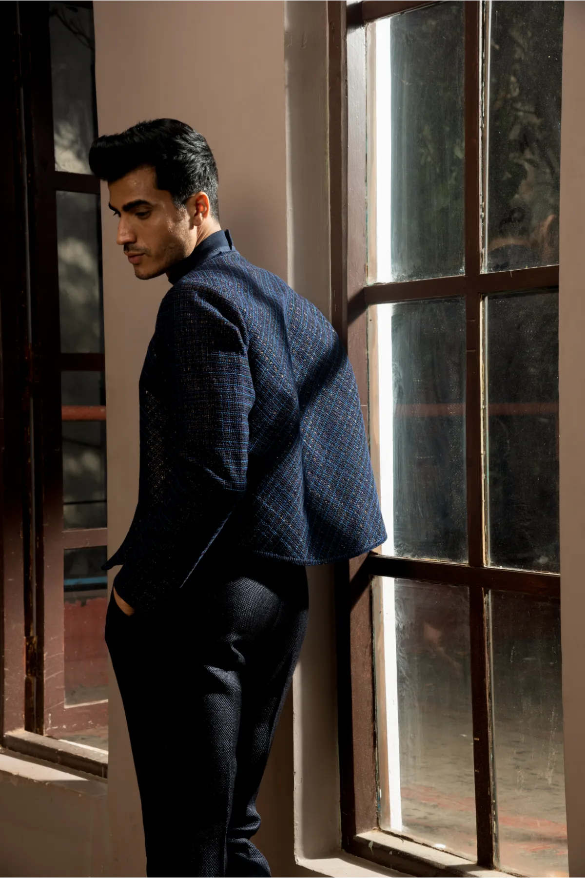 Dark blue textured jacket with pullover and pleated trousers